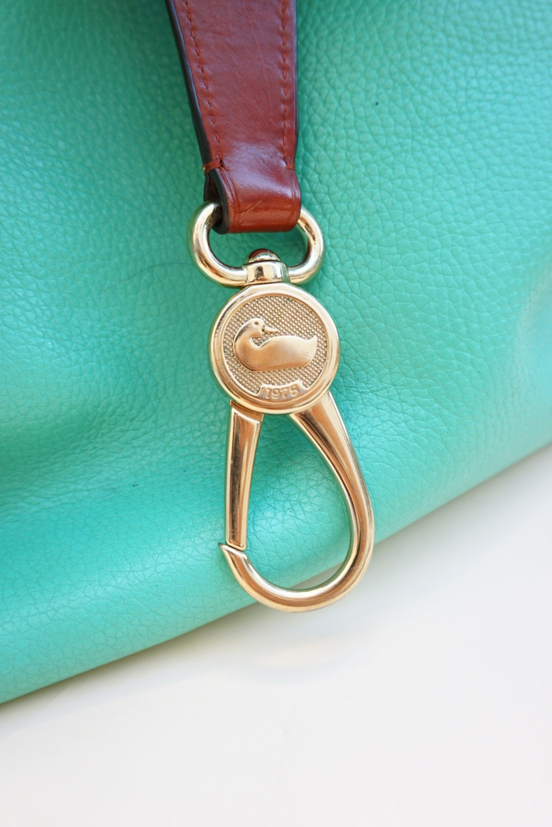 “Dooney & Bourke” Teal Pebble Grain Leather Logo Lock Shoulder Bag